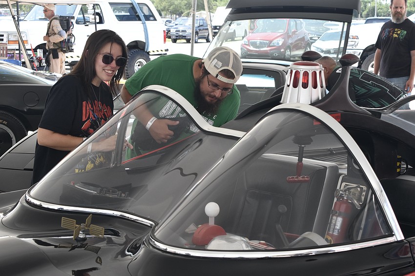 Shalease Moreno and her brother Mark Stephan relive childhood memories as they look at the Batmobile.