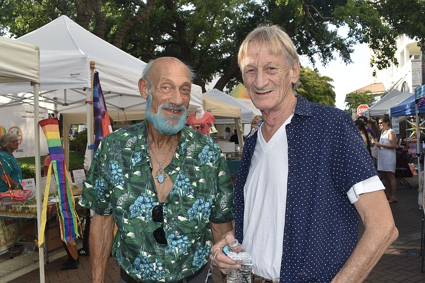 Jory Courtier and his friend Brad Blethen browse the vendor market.
