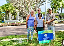 Team members at Longboat Harbour Condominiums and the Sarasota Bay Estuary Program are working together to show how residents and researchers can all contribute to building a stronger ecosystem. Coordinators recently put up new signs recognizing the work volunteers are doing to remove invasive plants and add Florida-friendly flora. Pictured are Mary and Rob Dice, Kakali Banerjee and Ken Stewart.