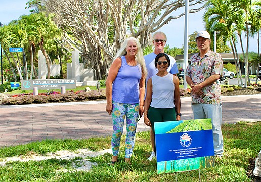 Team members at Longboat Harbour Condominiums and the Sarasota Bay Estuary Program are working together to show how residents and researchers can all contribute to building a stronger ecosystem. Coordinators recently put up new signs recognizing the work volunteers are doing to remove invasive plants and add Florida-friendly flora. Pictured are Mary and Rob Dice, Kakali Banerjee and Ken Stewart.