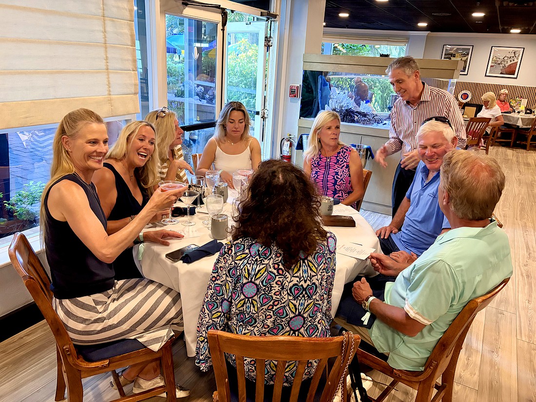 Michael Garey, owner of the Lazy Lobster restaurant, greets a table full of attendees on their second stop for the first Longboat Key Turtle Crawl fundraiser on May 7. The foodie fundraiser benefits sea turtle research being done this nesting season by Longboat Key Turtle Watch and Mote Marine.