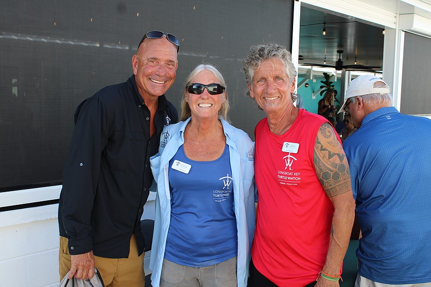 Jeff and Terri Driver and Leo Kissling welcome attendees to the first Longboat Key Turtle Crawl, starting at Lo' Key Island Grille.
