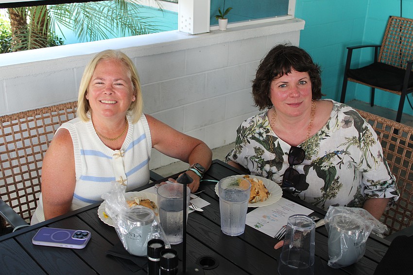 Jane Bradford and Sarah Merkley give their stamps of approval for the first course at Lo' Key Island Grille, American red snapper with lump crab risotto.