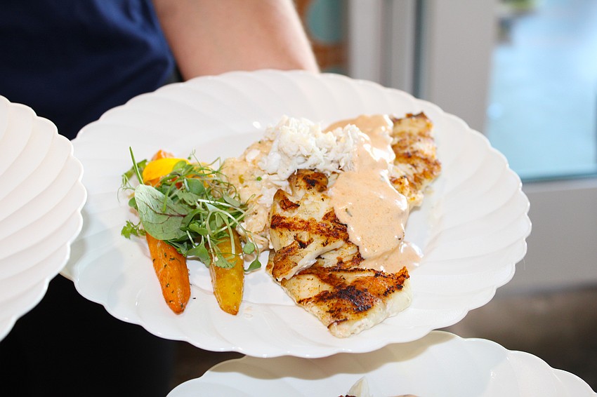 Courtlyn Terrill deftly dishes up three plates of American red snapper at the Turtle Crawl fundraiser.