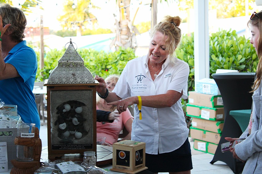 Longboat Key Turtle Watch team members including Bridgette Clark closed out the first Turtle Crawl restaurant tour with information about the new sea turtle nesting season and by pulling the raffle ticket winners.