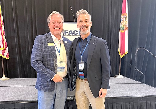 Greater Sarasota Chamber of Commerce Vice President Ed Hill (left) receives the Florida Association of Chamber Professionals Professional of the Year Award from Noel Martinez of the Palm Beach North Chamber of Commerce.