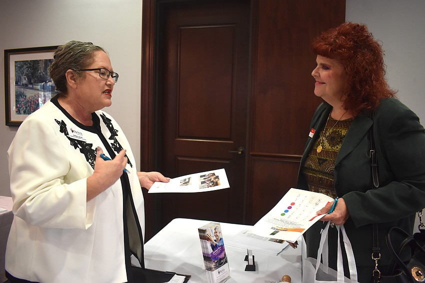 Kelleye Jacob, database and development coordinator of Aviva Senior Living, tells Sisterhood for Good member Jodi Allen that grant money would assist in providing a culinary program for 58 or more residents at their facility.