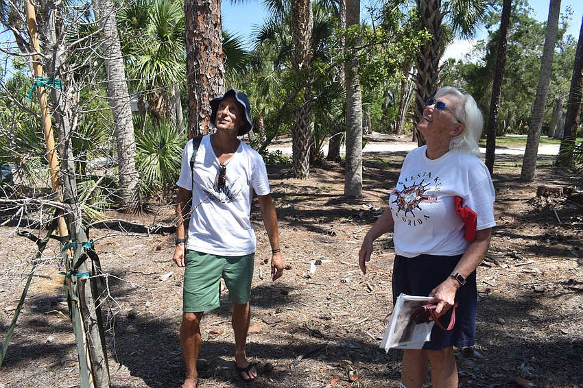 Dan Moriarty, community liaison and board member of the Tree Foundation, and Community Relations Co-Chair Janie Pratt look at the second tree planted on the property.