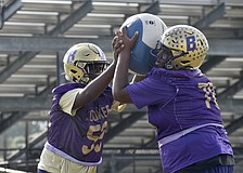Daryl Cherry (left) and Jamar Byrd (right) battle with a medicine ball during practice. Byrd, at 6-foot-4 and 315 pounds, was an offensive/defensive lineman as a sophomore in 2025.
