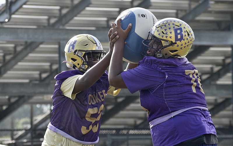 Daryl Cherry (left) and Jamar Byrd (right) battle with a medicine ball during practice. Byrd, at 6-foot-4 and 315 pounds, was an offensive/defensive lineman as a sophomore in 2025.