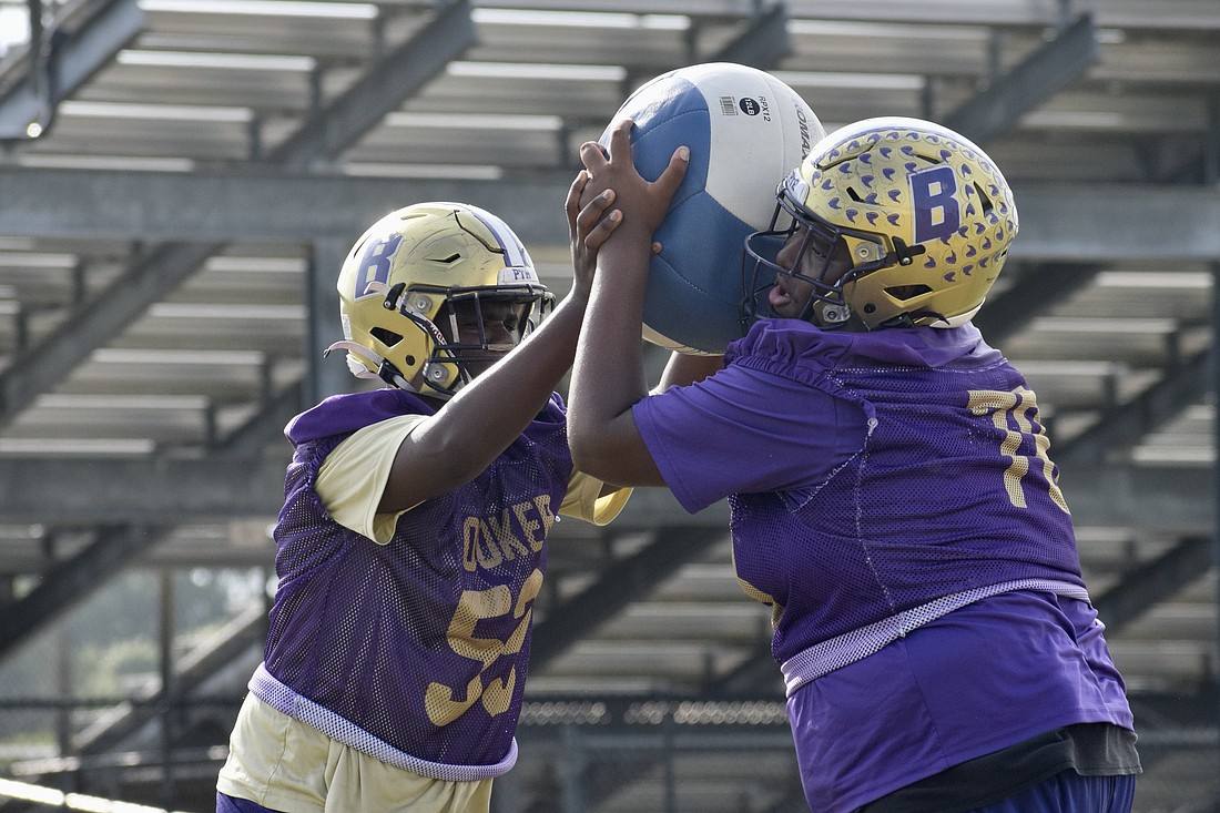 Daryl Cherry (left) and Jamar Byrd (right) battle with a medicine ball during practice. Byrd, at 6-foot-4 and 315 pounds, was an offensive/defensive lineman as a sophomore in 2025.