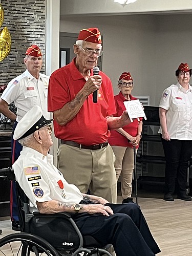 Jeff Kingdon, chairman of the Flagler County Veterans Advisory Council, presents Navy veteran Linwood "Nemo" Farmer with a handmade wooden plaque in celebration of his 101st birthday. Courtesy photo