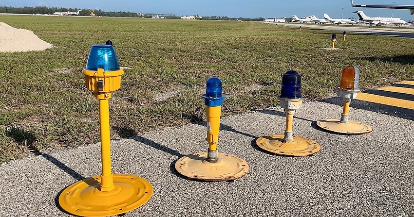 Naples Airport's new elevated airfield lights (left) will be 20 inches above ground level, higher than the existing lighting system.
