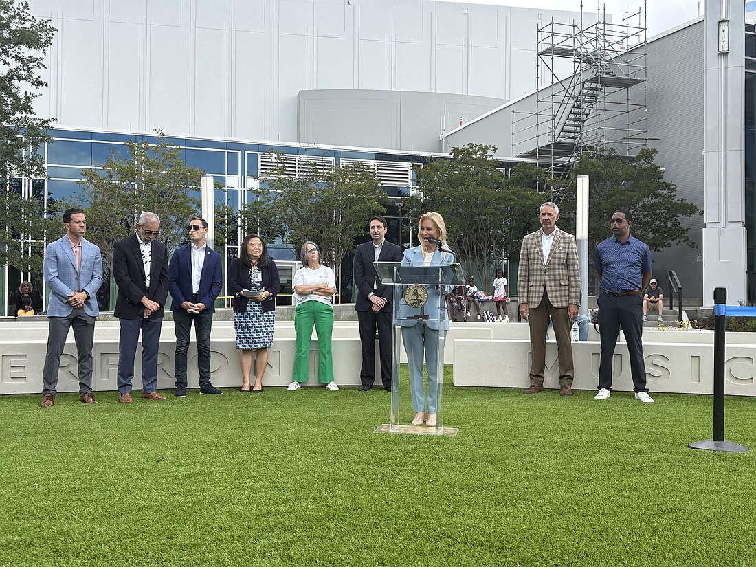 Mayor Donna Deegan speaks at the May 13 park opening of Riverfront Music Garden park in Downtown Jacksonville. Behind her are City Council members, city employees and Groundwork Jax CEO Kay Ehas.