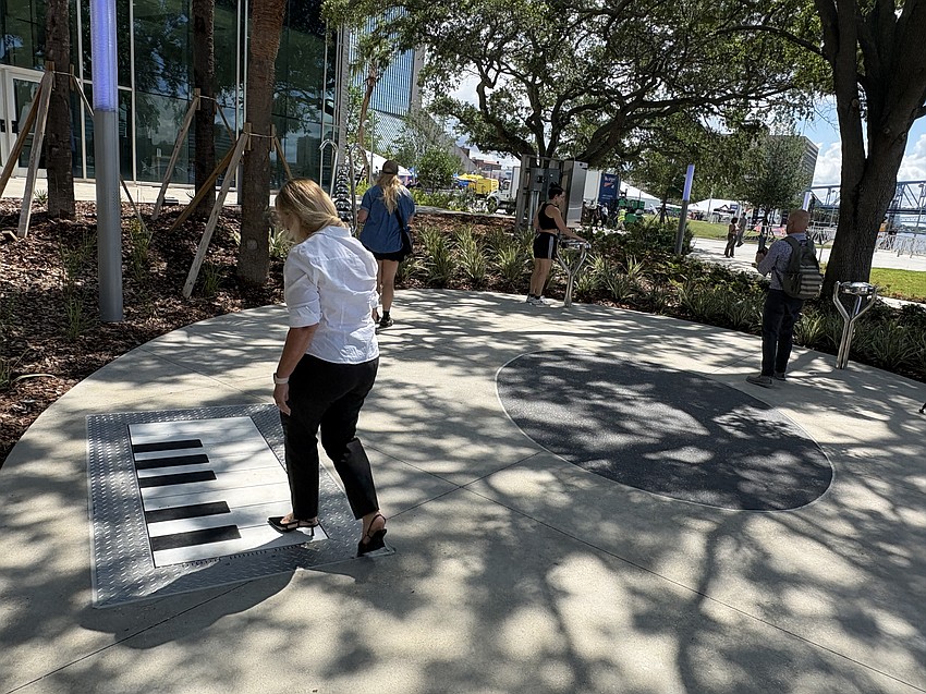 Riverfront Music Garden features fixtures that allow visitors to play music, including a piano embedded in the ground.