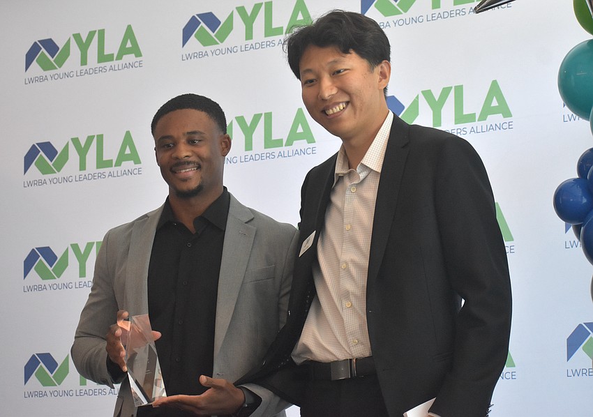 Tre Alexandrea, the chief operations officer of Aginto and head basketball coach at Bayshore High School, is presented the 