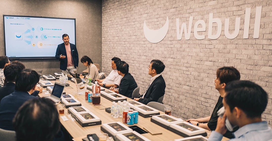 Webull CEO Anthony Denier speaks to company partners from Japan and Singapore in a 2024 photo. The company, after moving its headquarters from New York, now owns a 150,000-square-foot building in the Carillon business park in St. Petersburg.