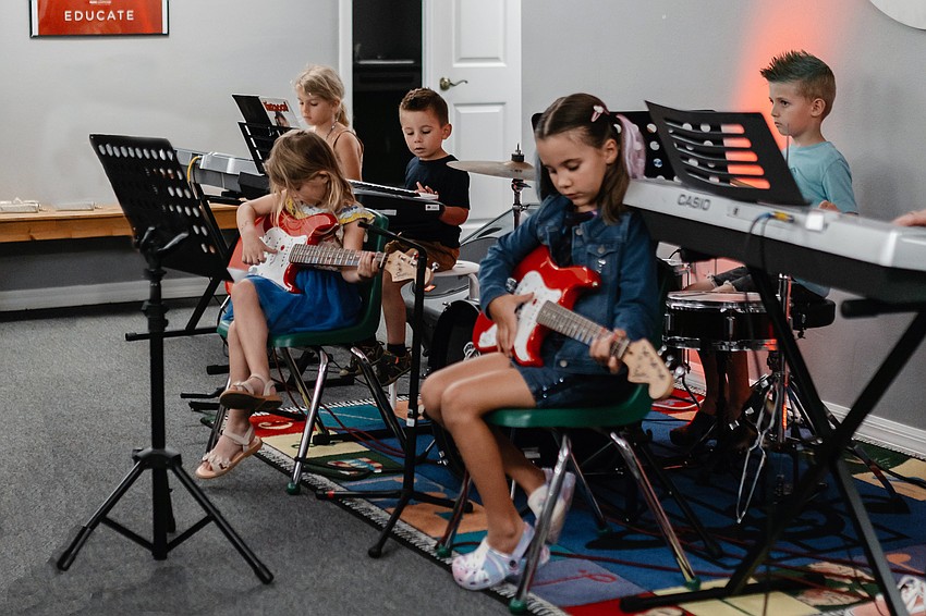 Students in grades 1-5 receive instruction on guitars and keyboards at Music Compound’s Summer Camp. Students in grades 1-5 receive instruction on guitars and keyboards at Music Compound’s Summer Camp.
