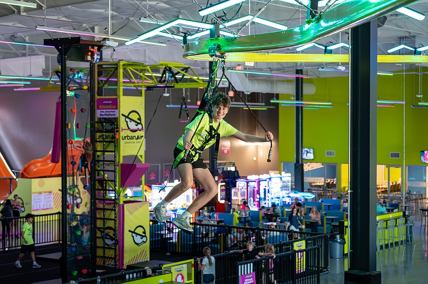 Luka Mikanovic takes to the Sky Rider, an indoor zip line that glides above the action at Urban Air Adventure Park.