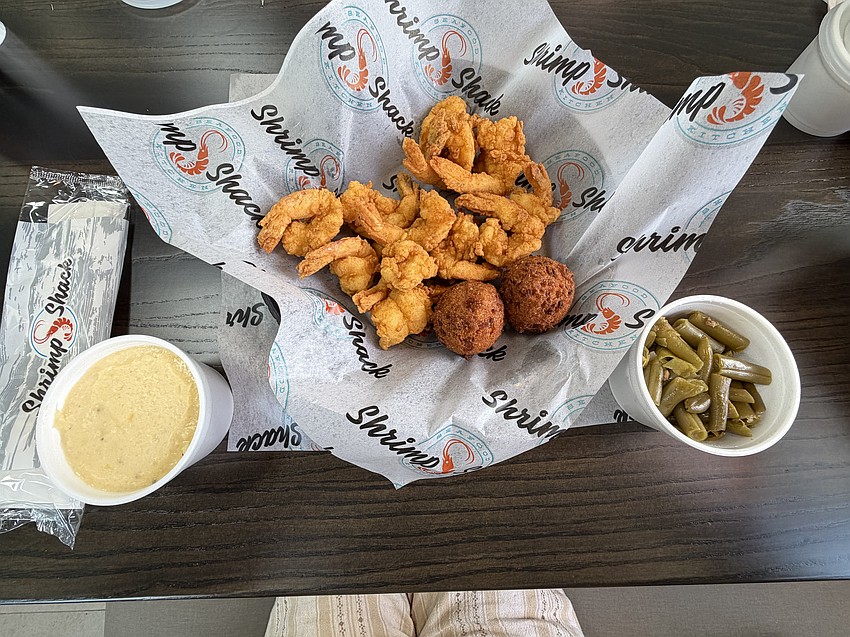 A meal of shrimp, hush puppies and two sides - here, cheese grits and green beans - is priced at $13.