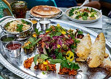 A colorful spread of kebabs, house-made sauces and sides showcases the restaurant’s bold, cross-cultural approach to Mediterranean cuisine.