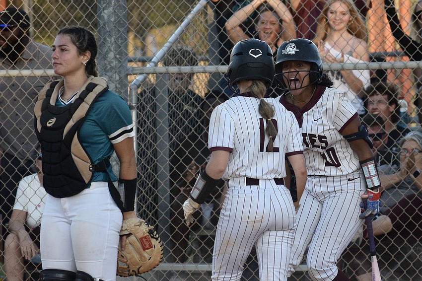 Cooper Jones (center) and Sarai Castro (right) celebrate at the plate following the Pirates' first run of the 5A-3 regional final. They're two of seven freshmen on the team. Cooper Jones (center) and Sarai Castro (right) celebrate at the plate following the Pirates' first run of the 5A-3 regional final. They're two of seven freshmen on the team.