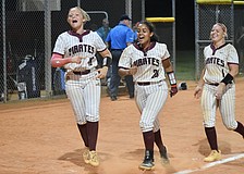 Cady Jones (left), Sarai Castro (center) and Kaydence Evans (right) celebrate Braden River High softball's first state semifinals berth since 2016. The Pirates are now two wins away from their first state title.