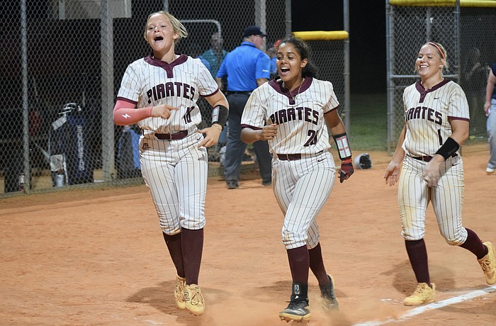 Cady Jones (left), Sarai Castro (center) and Kaydence Evans (right) celebrate Braden River High softball's first state semifinals berth since 2016. The Pirates are now two wins away from their first state title.