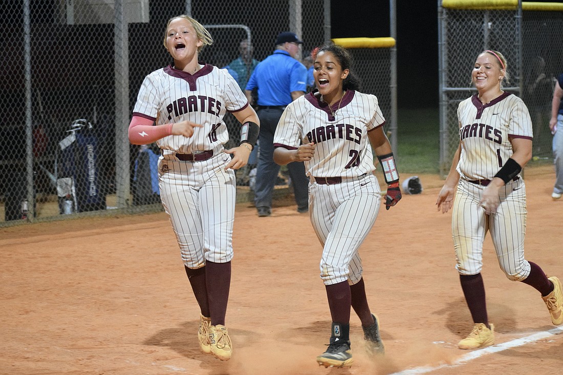 Cady Jones (left), Sarai Castro (center) and Kaydence Evans (right) celebrate Braden River High softball's first state semifinals berth since 2016. The Pirates are now two wins away from their first state title.