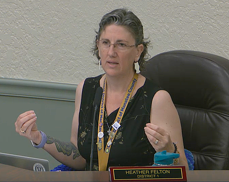 School Board Member Heather Felton took off her blazer during the May 5 workshop to show her sleeveless shirt is appropriate for students in the Florida heat.