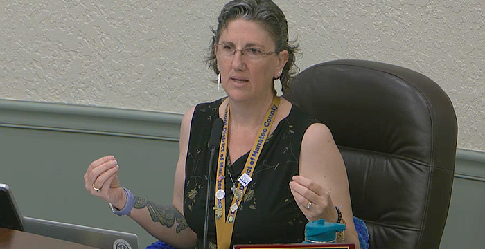 School Board Member Heather Felton took off her blazer during the May 5 workshop to show her sleeveless shirt is appropriate for students in the Florida heat.