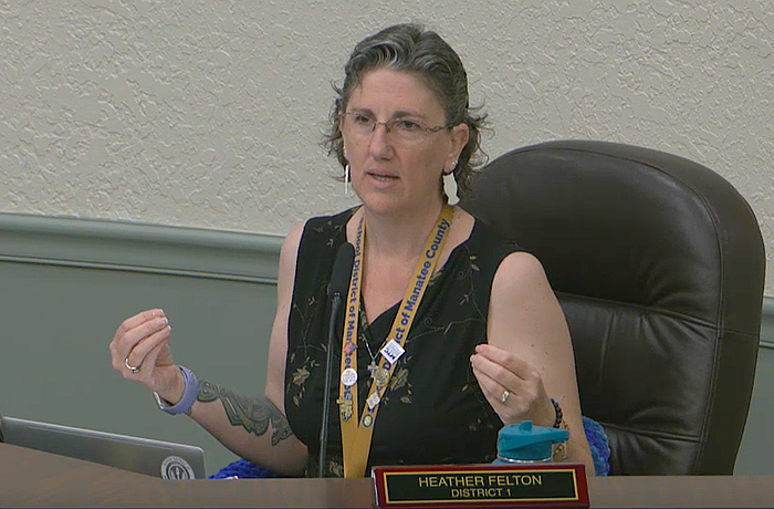 School Board Member Heather Felton took off her blazer during the May 5 workshop to show her sleeveless shirt is appropriate for students in the Florida heat.