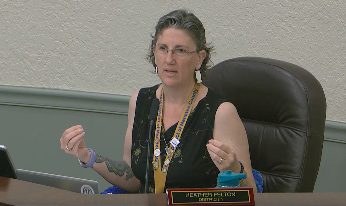School Board Member Heather Felton took off her blazer during the May 5 workshop to show her sleeveless shirt is appropriate for students in the Florida heat.