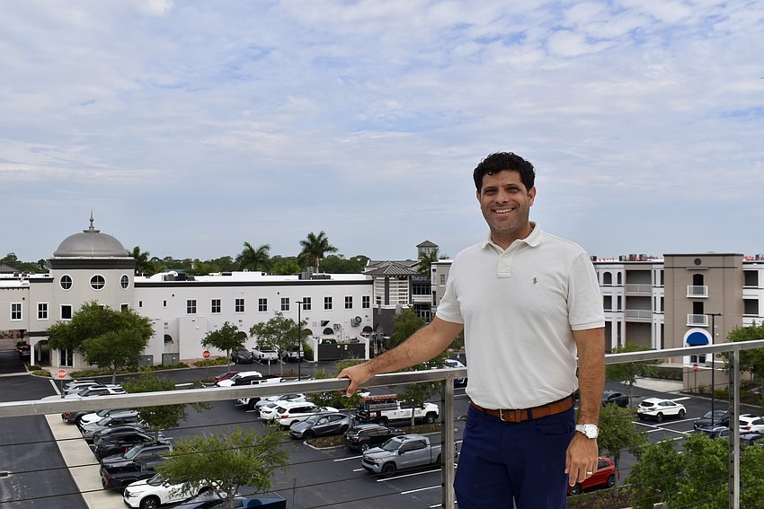 Realtor Adam Myara stand on a rooftop terrace at Lakeshore Townhomes. The project is under construction on Rodeo Drive behind Main Street at Lakewood Ranch.