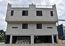 Each townhome features a two-car garage and a rooftop terrace.