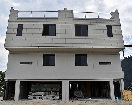 Each townhome features a two-car garage and a rooftop terrace.