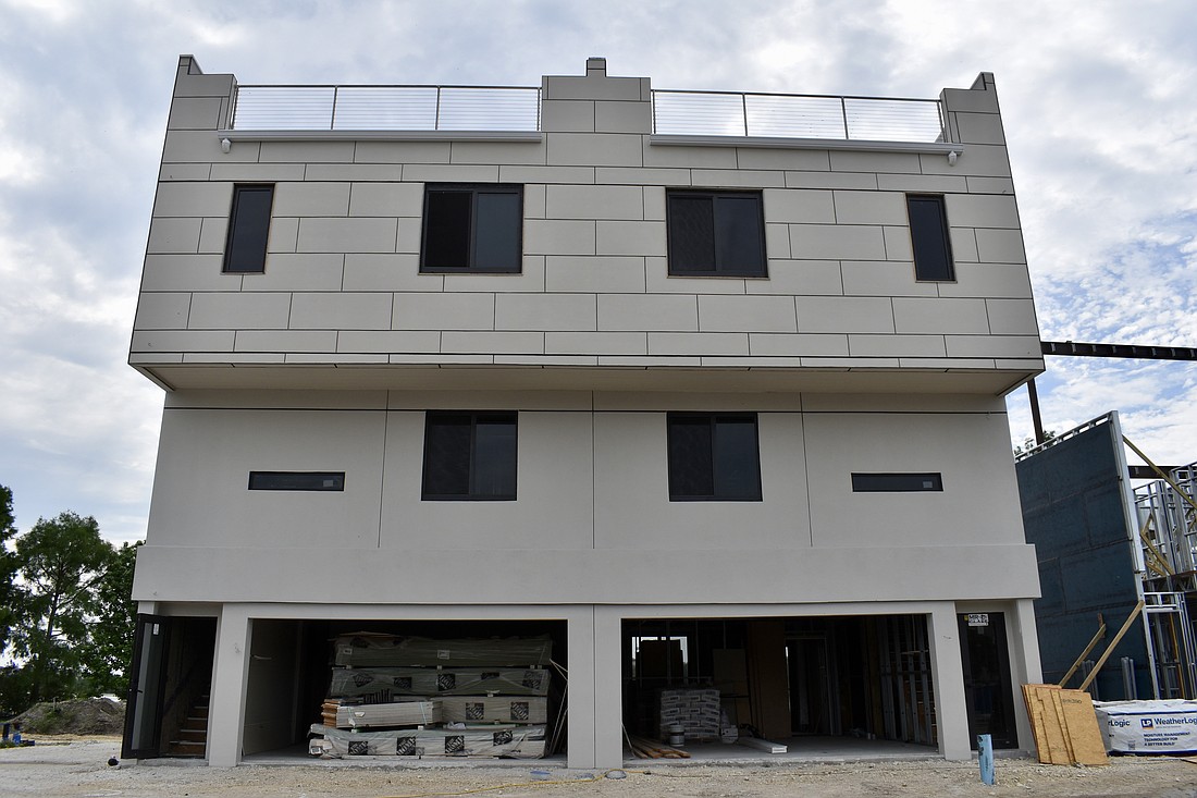 Each townhome features a two-car garage and a rooftop terrace.