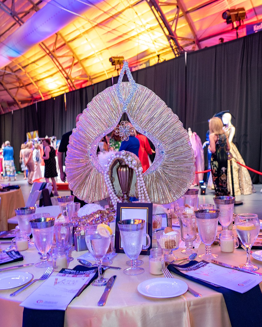 A circus headpiece acts as the centerpiece for this table.