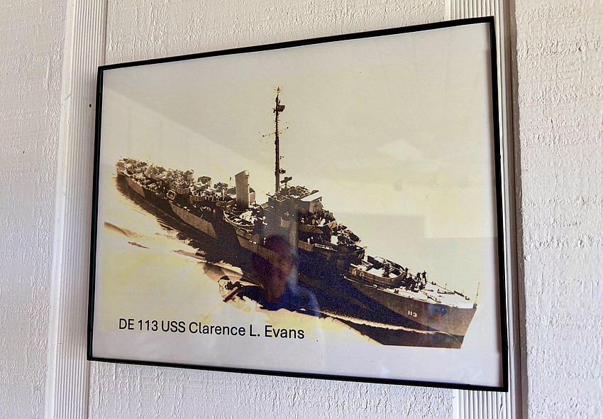 U.S. Navy veteran Harold Goldstein gazes at a photo of the ship he sailed aboard to England and back four times when he was 17 years old. This year, he celebrates his 100th birthday.