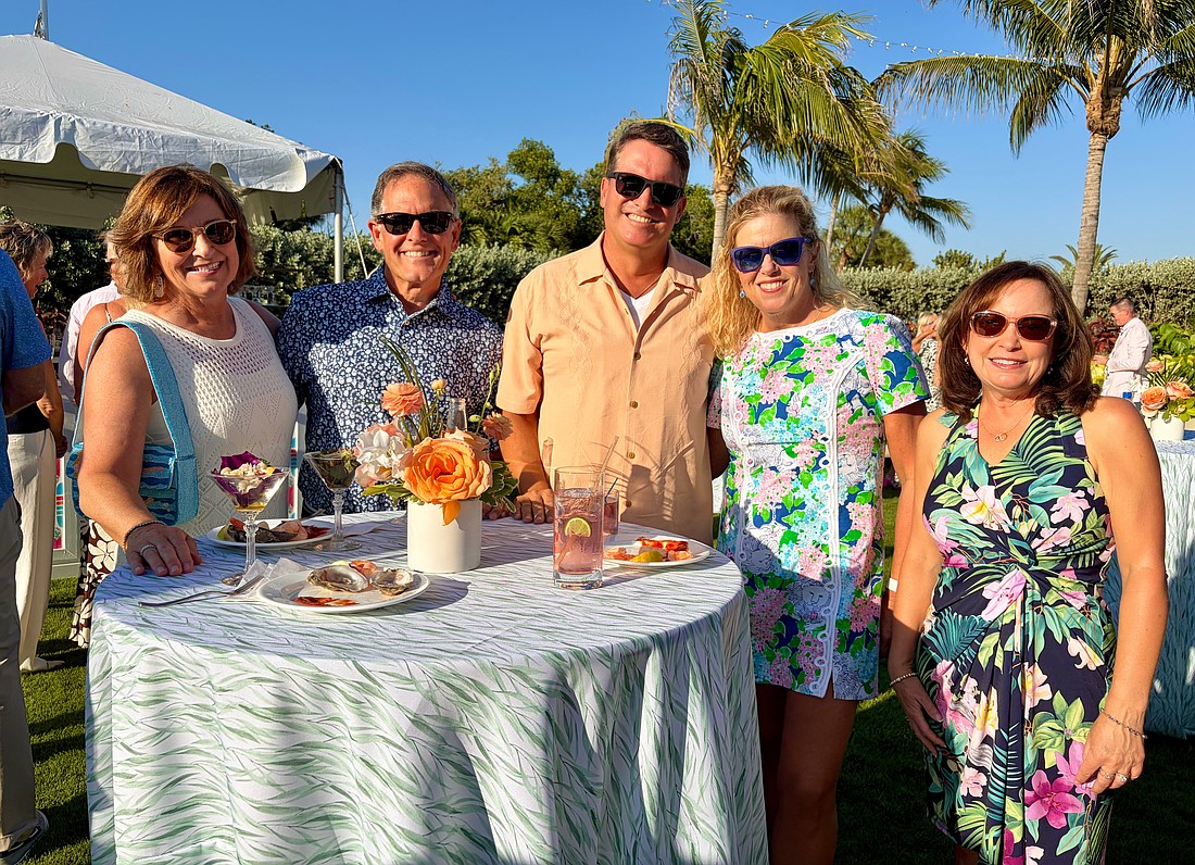 Karen and Gregg Sweeney, Chris and Cathy Goglia, and Debbie McPeak socialize at the Longboat Key Club's farewell lawn party on May 15.