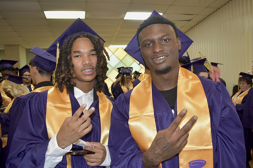 Kevion Carey and Villius Charles prepare for graduation.