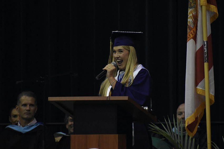 Commencement speaker Kila Sons raises some enthusiasm for graduation.