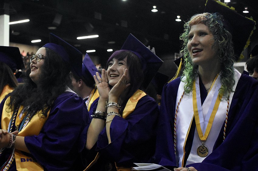 Harmony Brooke Himler, Gwendolyn Alice D'souza and Kalina Jade Ernst cheer on the school's modern band from their seats.
