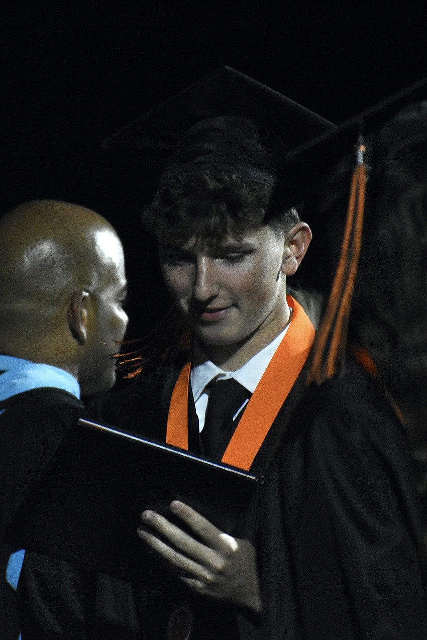 Austin Atkinson receives his diploma.
