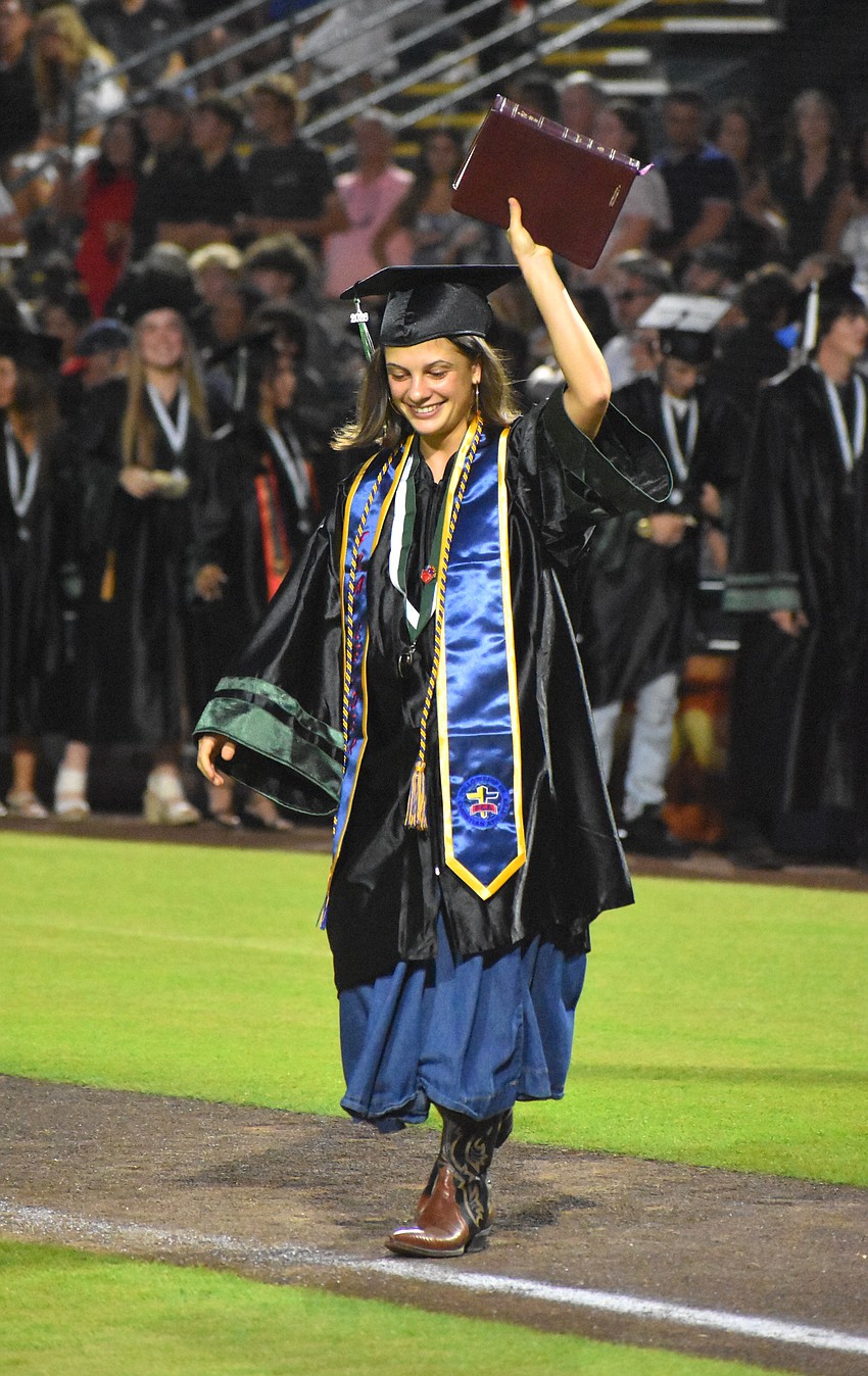 With a Bible in hand, Collete Testa says she feels blessed to be graduating and following God’s plan for her life.