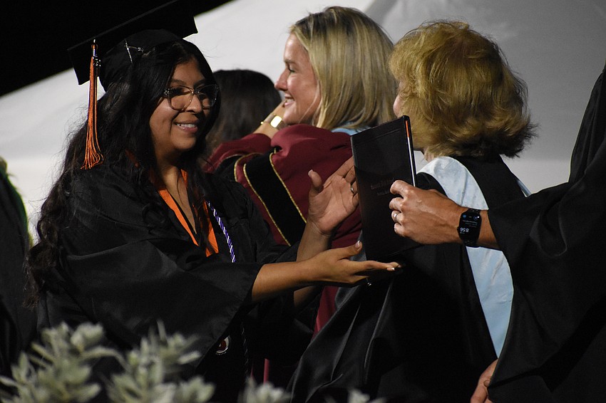Daniela Elizarraras-Saavedra receives a diploma.