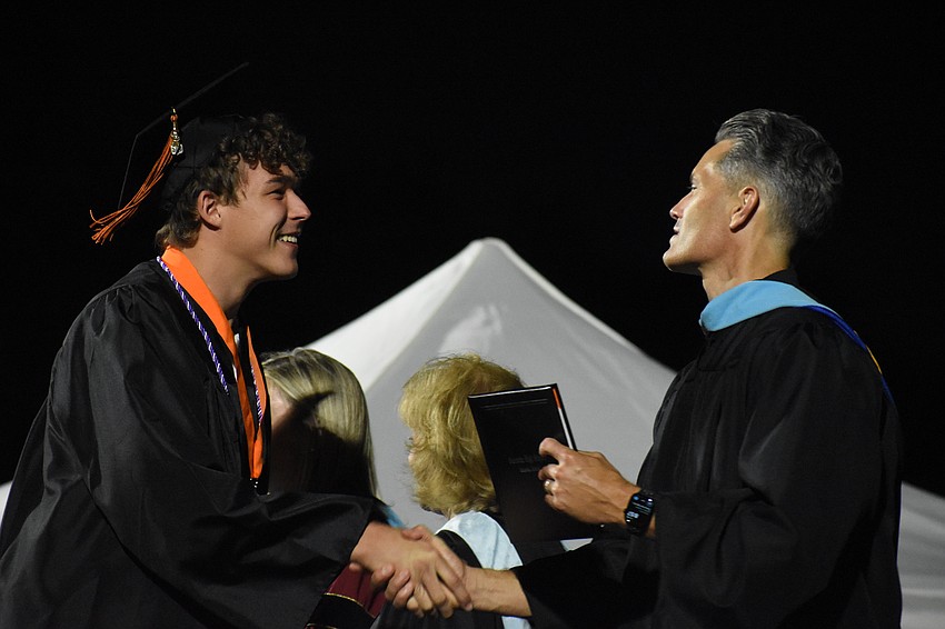 Carter Flerlage shakes hands with Superintendent of Schools Terry Connor.