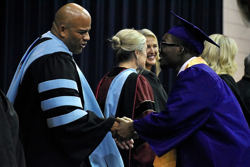 Nate Francis, executive director of secondary schools, greets Garren Branch