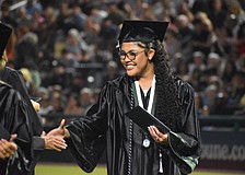 Sophia Wiley makes her way down the row to shake hands after she receives her Lakewood Ranch High School diploma at Lecom Park May 18.