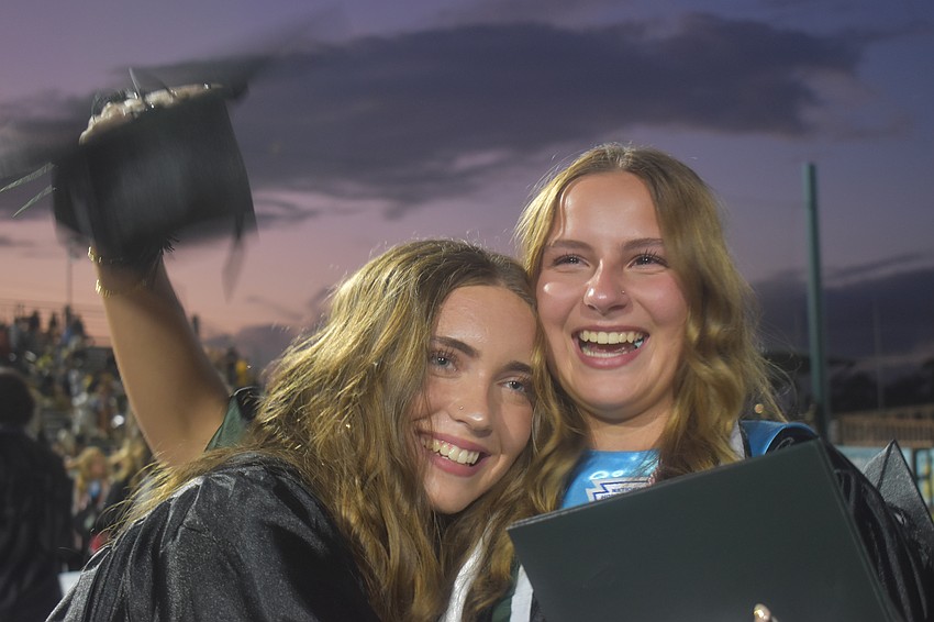 Layla Benshoff and Madelyn Boyd celebrate after the conclusion of the Lakewood Ranch High School graduation ceremony at Lecom Park.
